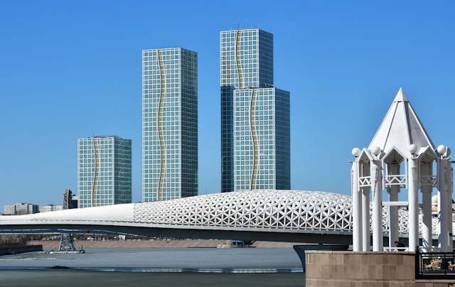 Photo of modern high buildings and bridge across a river