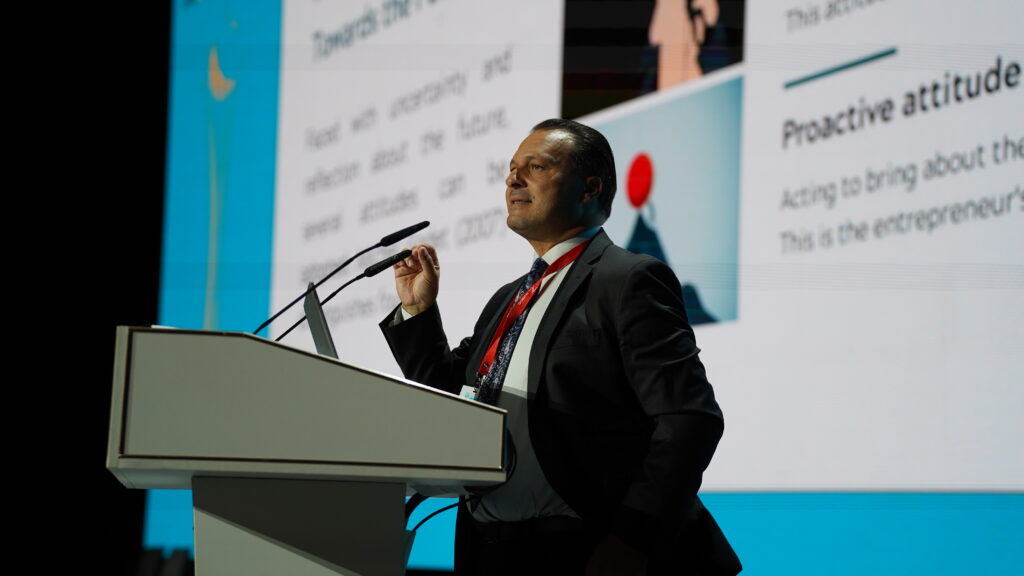 An image of a person standing behind a podium with microphones